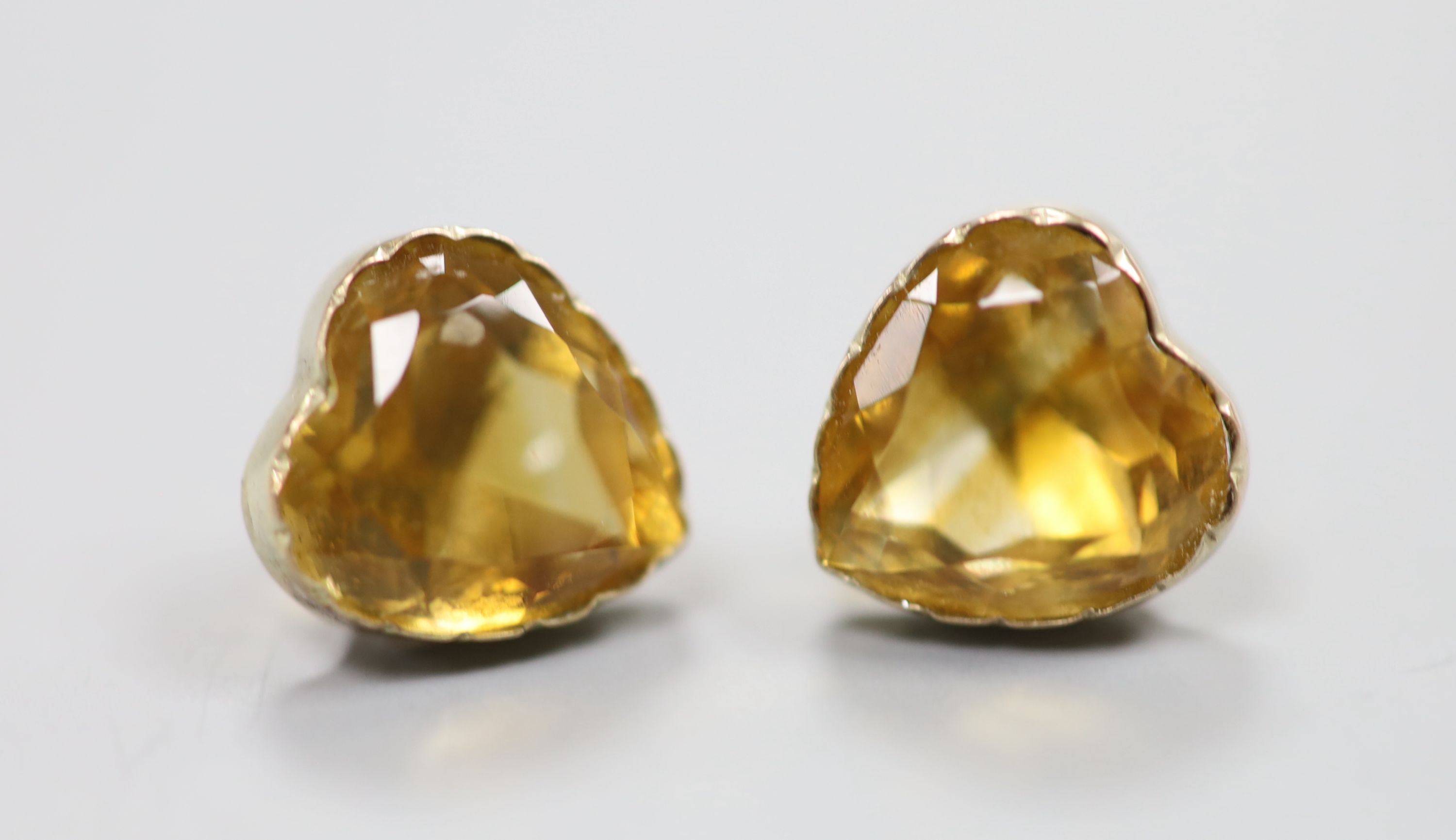 A yellow metal and heart shape citrine pendant, 10mm and pair of matching ear studs(no butterflies), gross 3.6 grams.